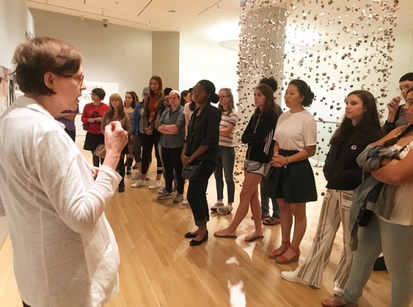 Presenter talking to group at museum