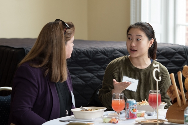 2 event goers speaking to each other