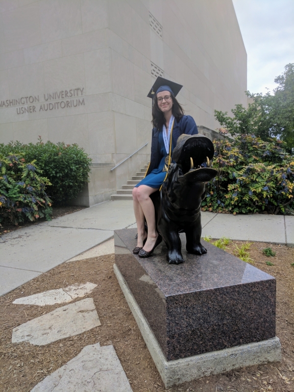 Graduate sitting on hippo statue
