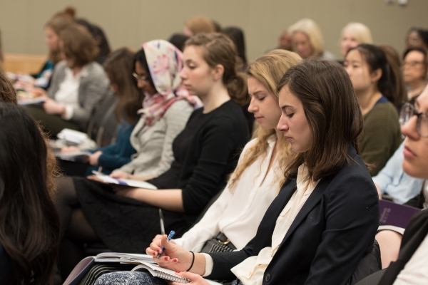 audience members taking notes