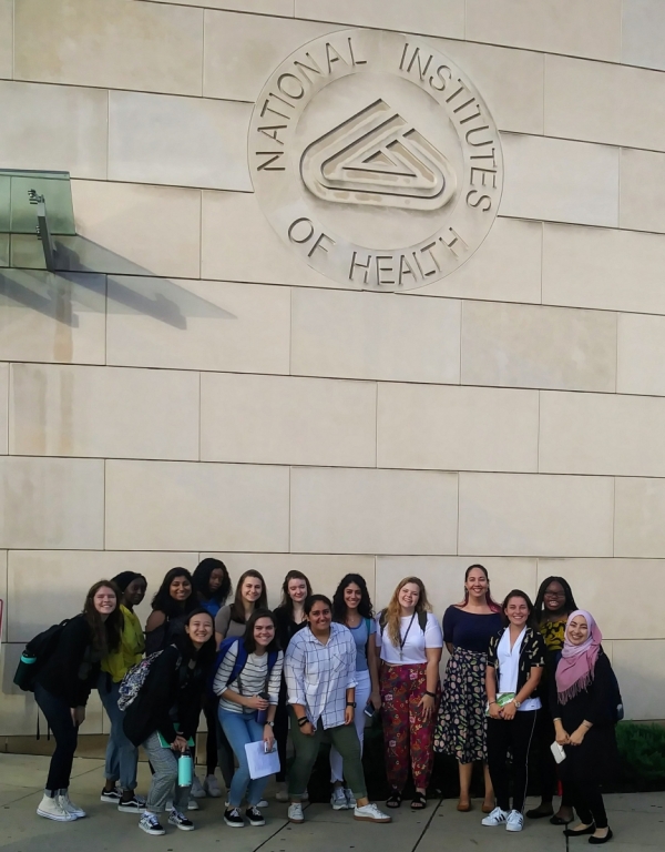 SHM students pose in front of the NIH Visitor Center