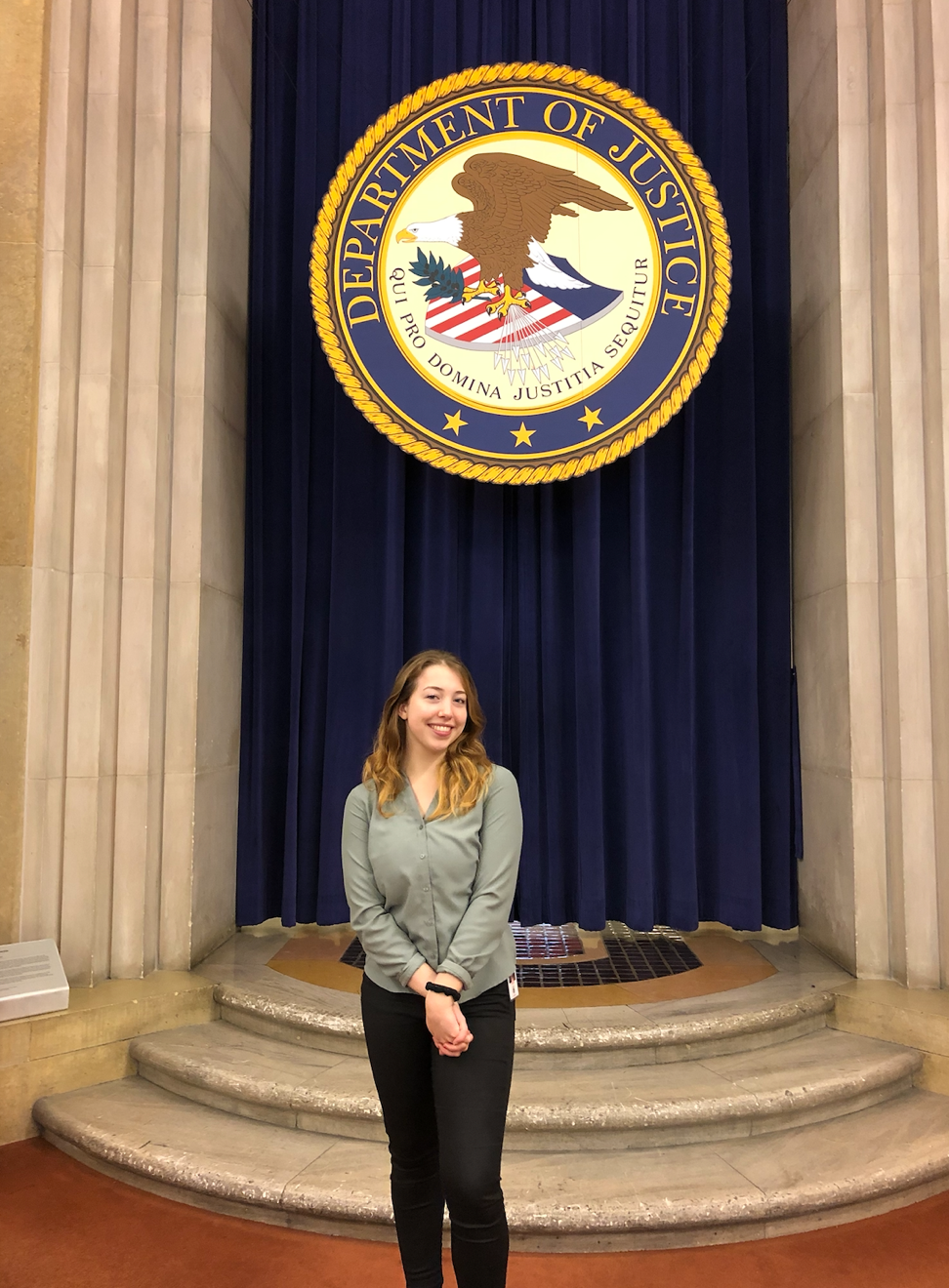 Picture of Ruby standing in front of the Department of Justice