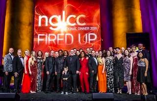 Conference members in front of the NGLCC sign