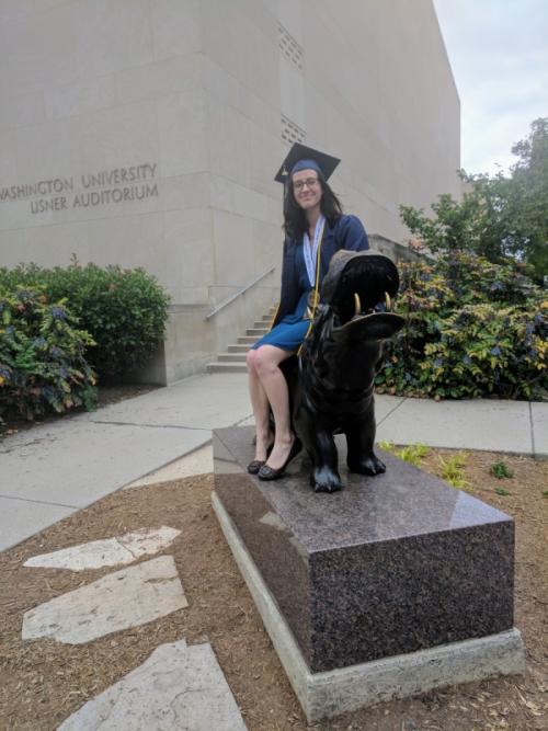 Graduate sitting on hippo statue