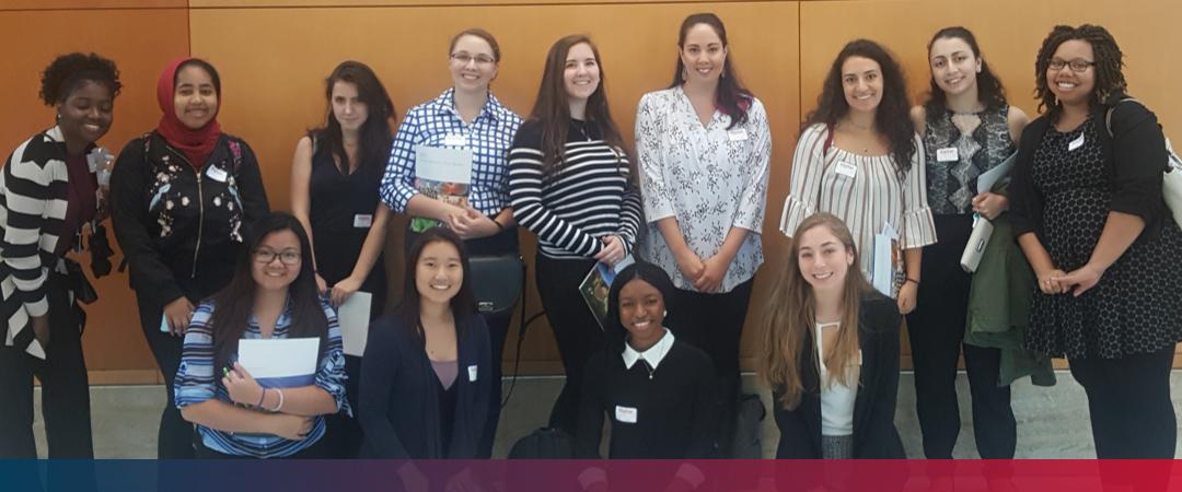 Students standing in front of a wall