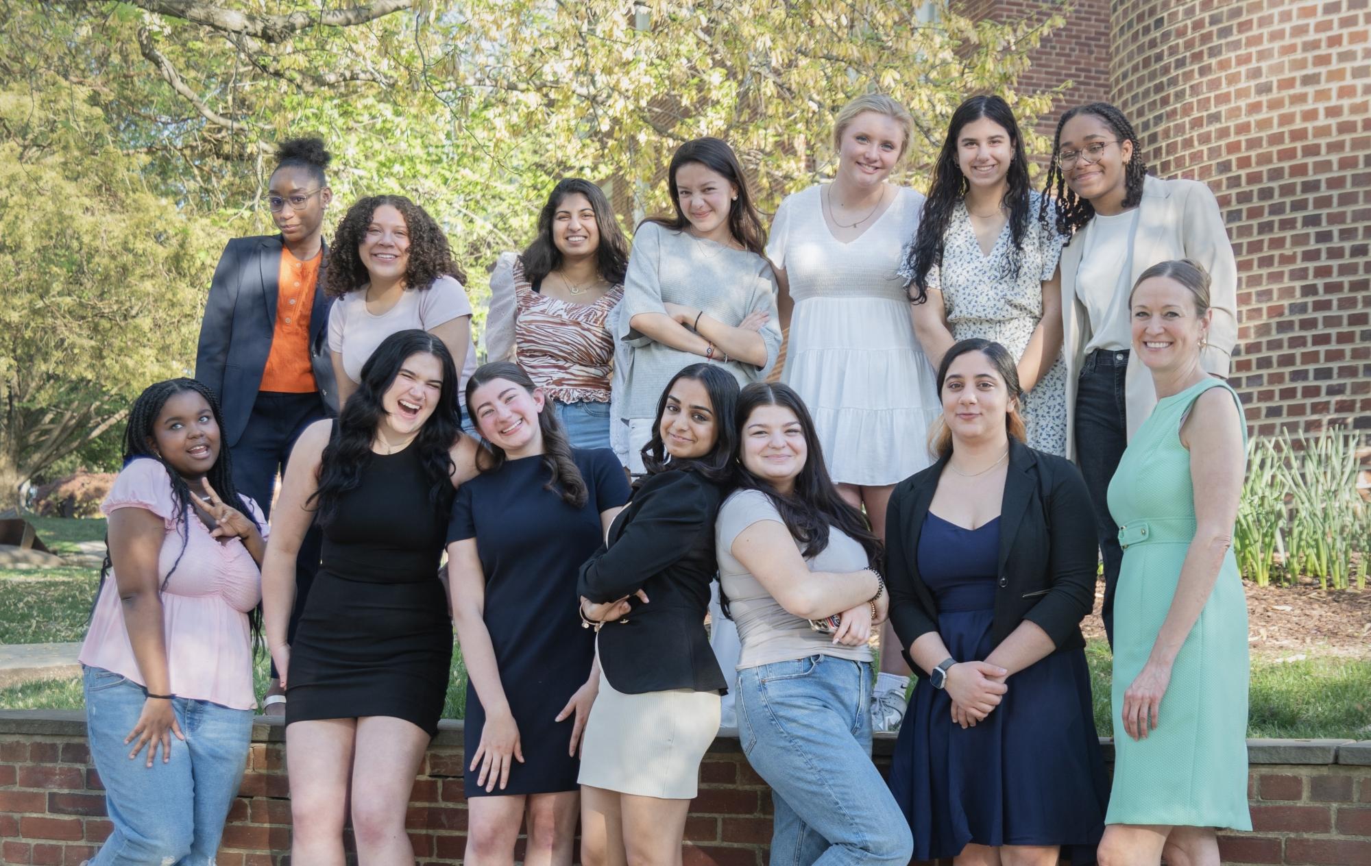 Group of students in front of GW summit banner