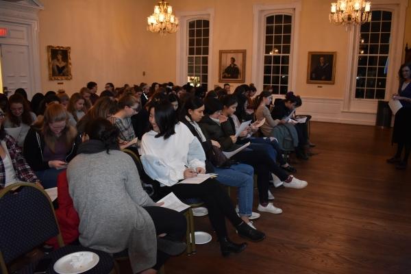 Audience members taking notes
